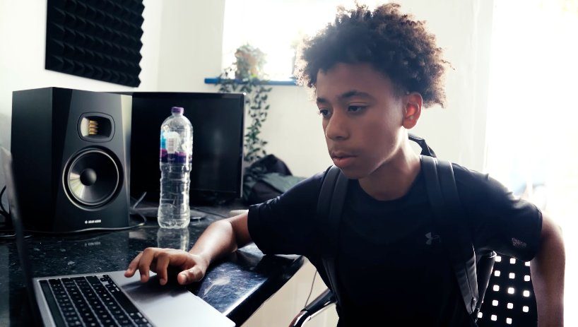 Young person at the laptop learning to engineer a track