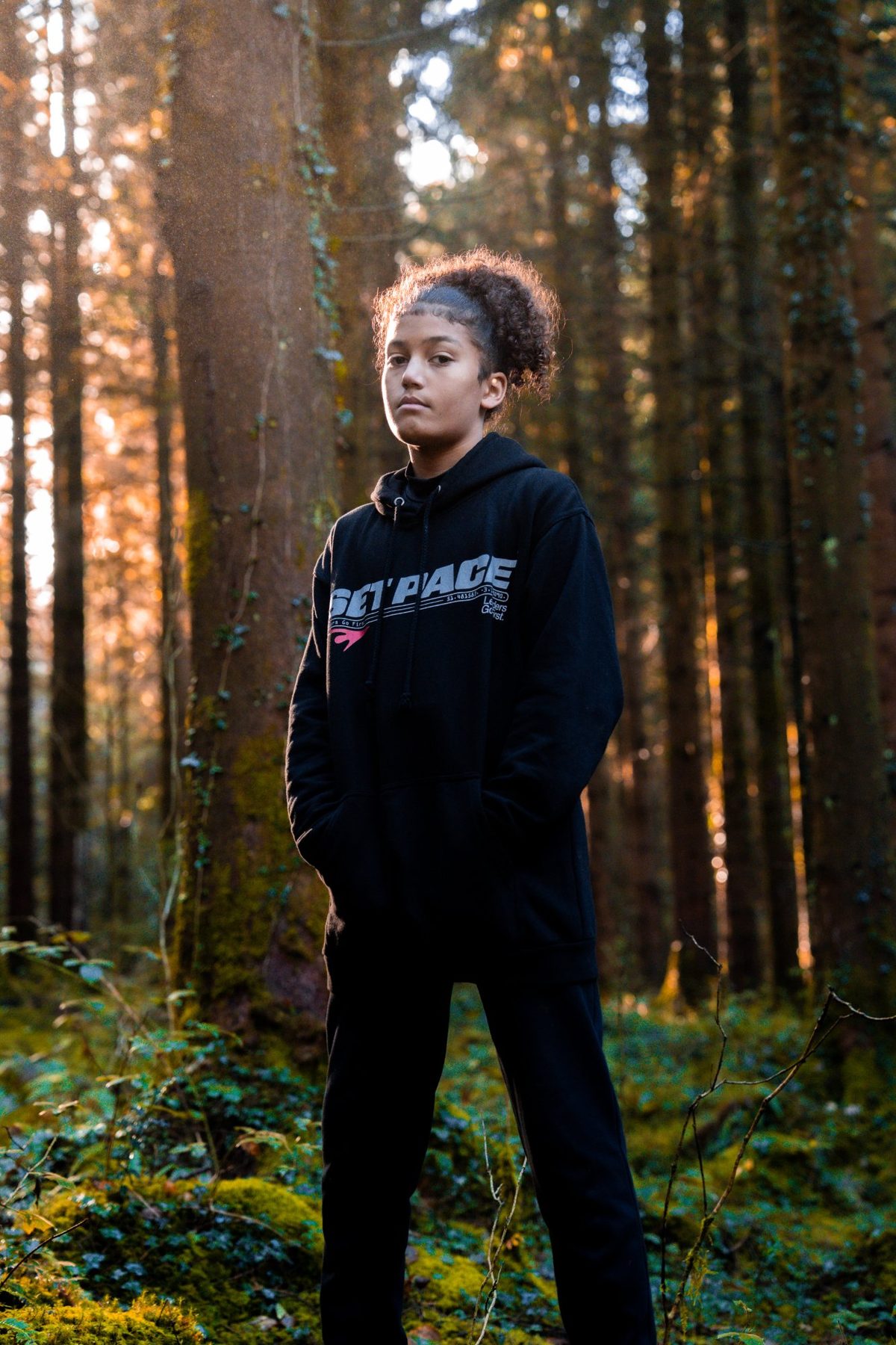 Marcellus standing in the forest wearing Set Pace gear